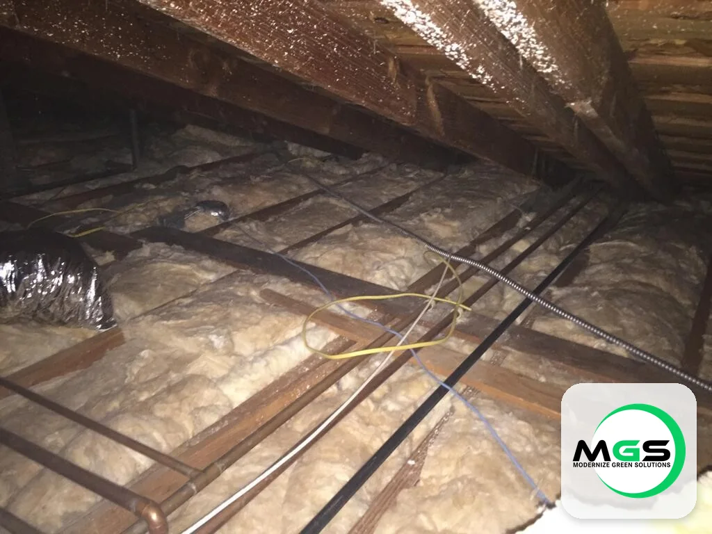 Attic insulation around wiring and framing by Modernize Green Solutions