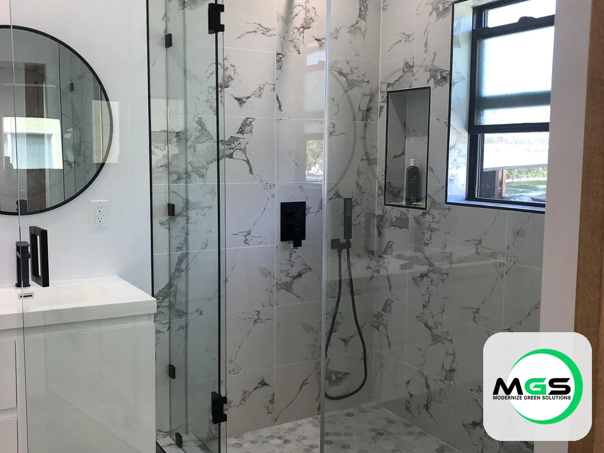 Marble walk-in shower with a glass enclosure by Modernize Green Solutions