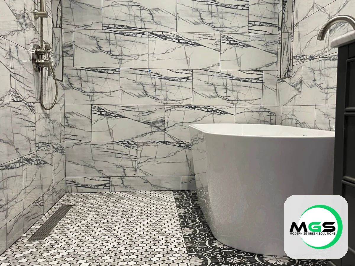 Marble bathroom remodel with a freestanding soaking tub by Modernize Green Solutions