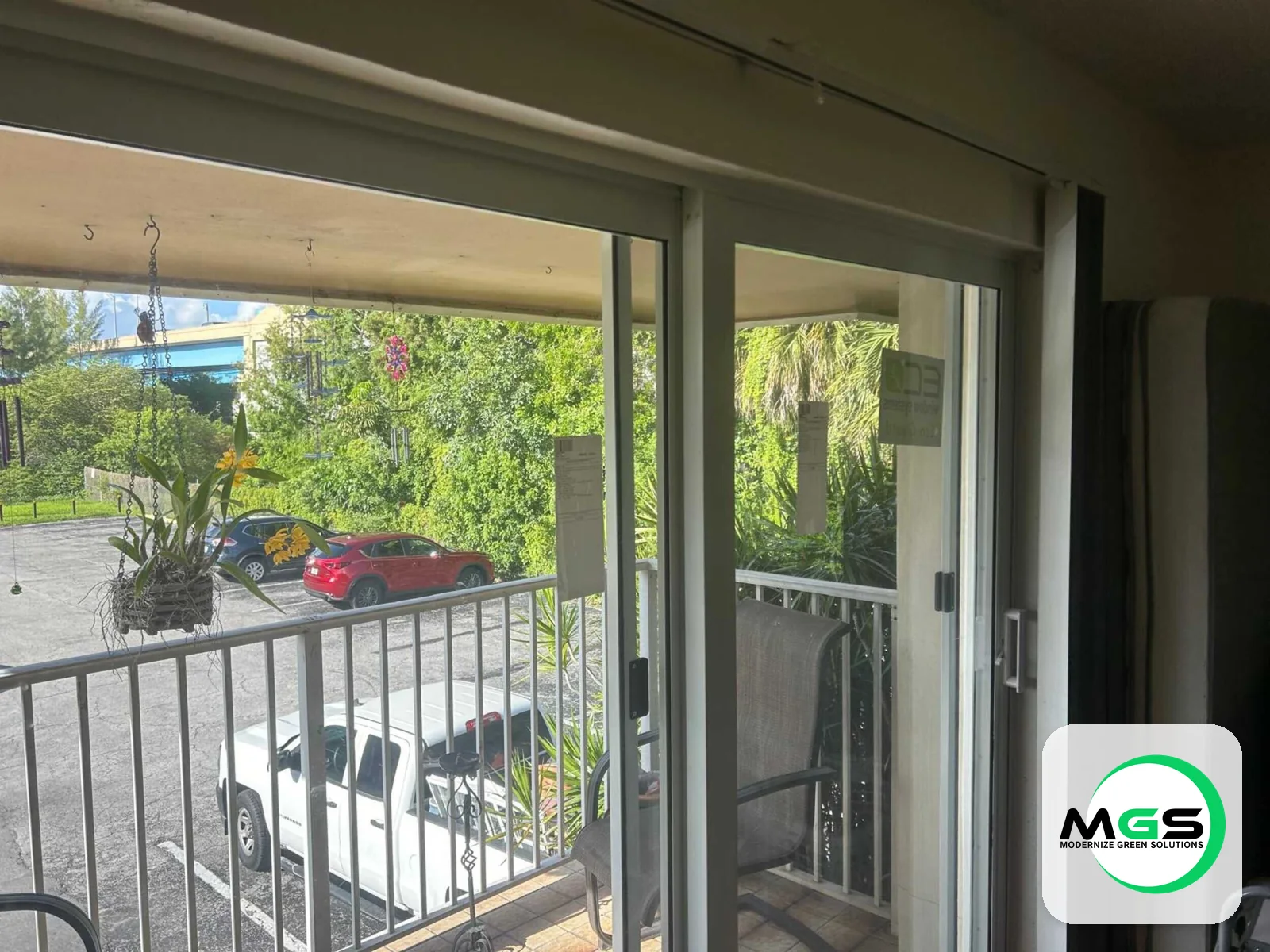 Sliding glass door to balcony by Modernize Green Solutions
