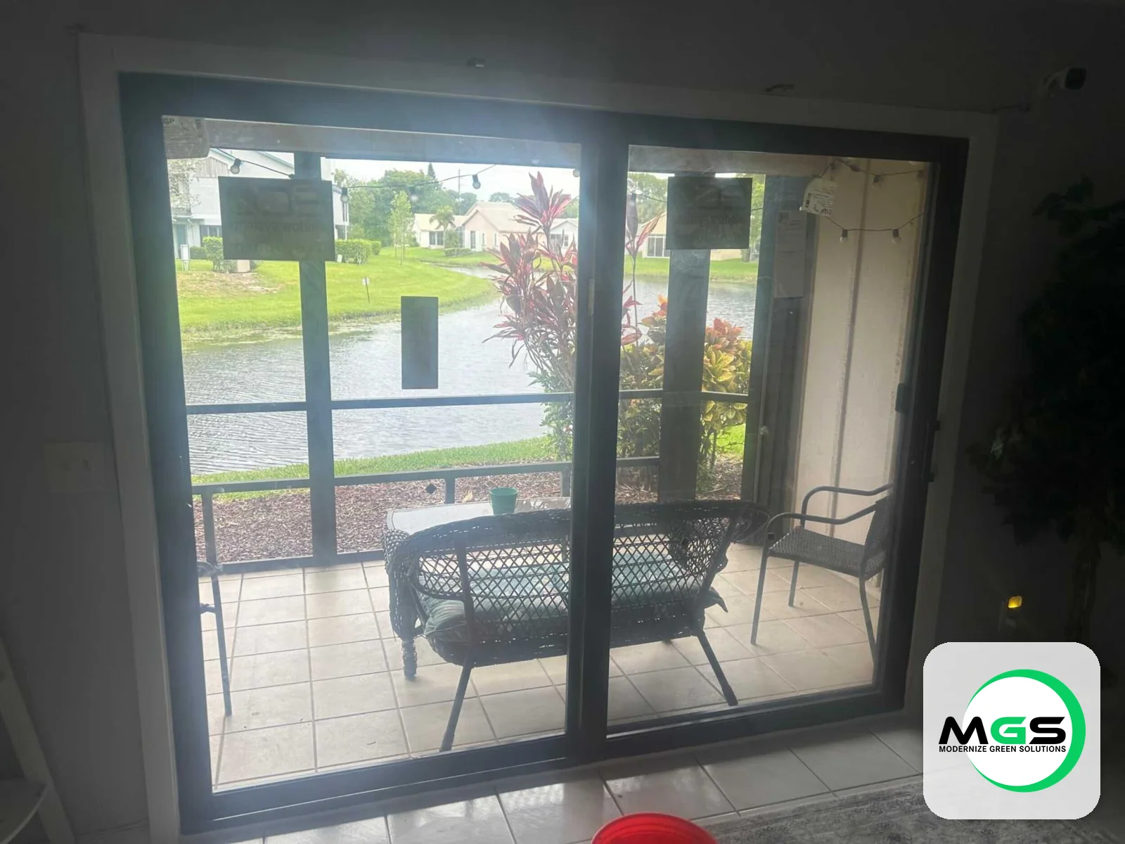 Sliding glass doors to patio by Modernize Green Solutions